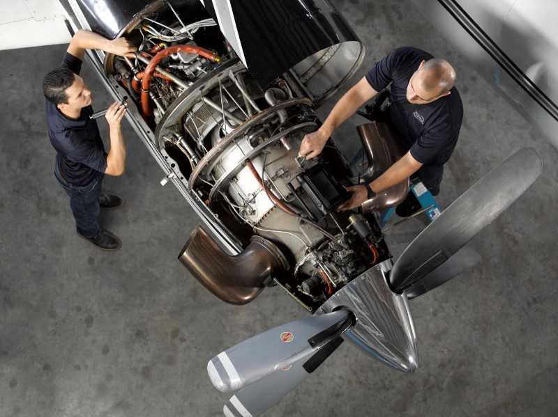 Mechanics working on airplane engine